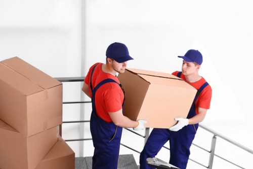 Professional movers handling furniture during a local home relocation