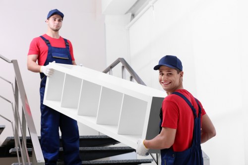 Man and van removals loading furniture for a local move in Merton