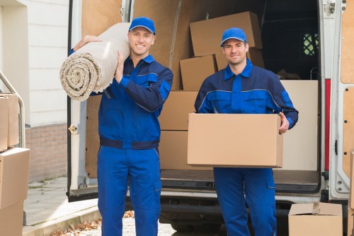 Careful loading of household items into a van for a Merton move