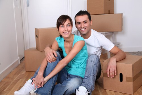 Local removal helpers unloading furniture at a Merton property