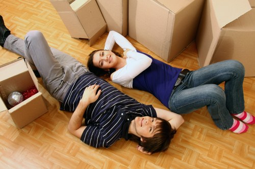 Packed moving boxes and furniture ready for transport in Merton