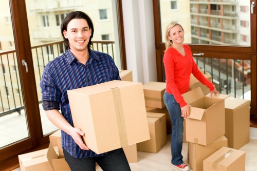 Team organising an office relocation with labelled boxes and furniture setup